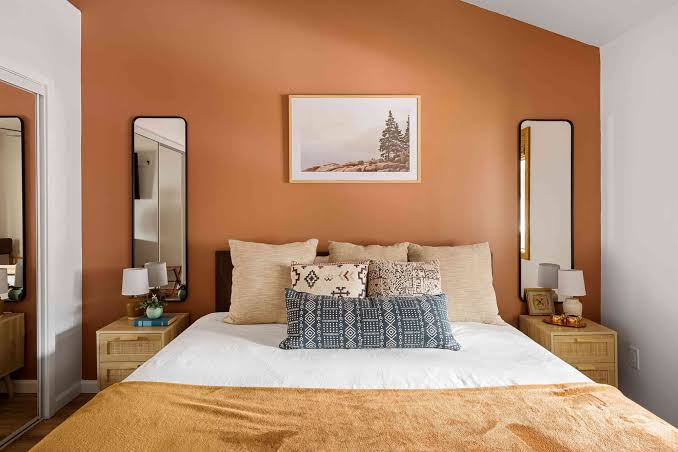 Warm terracotta accent wall with clean ceiling finish and white trim by an interior painter in Ventura, CA.