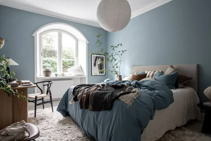 Soft blue bedroom walls with smooth interior paint and bright white trim by an interior painter in Ventura, CA.