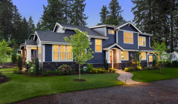 Navy blue paint finish with crisp white trim and stone accents by an exterior painter in Orange County, CA.